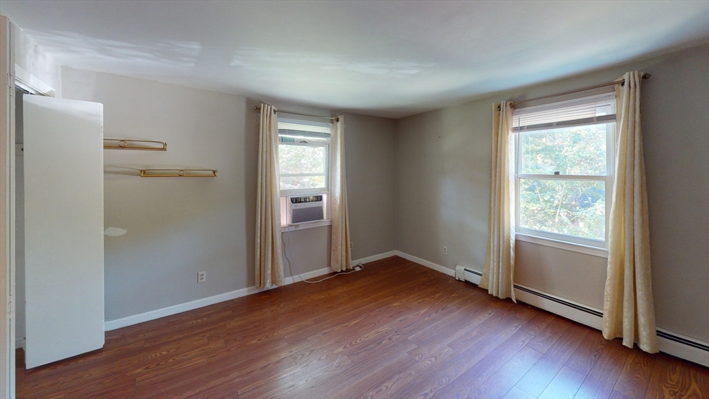 18 Cranston Circle Woburn, MA 01801 - Photo 7 of 19 an empty room with wooden floor closet and windows
