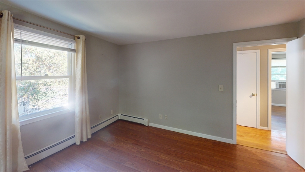 18 Cranston Circle Woburn, MA 01801 - Photo 9 of 19 an empty room with wooden floor and windows