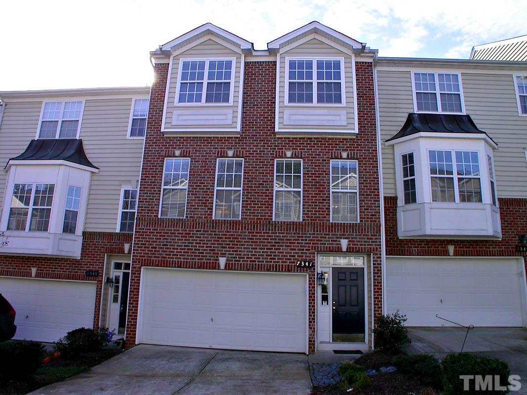 7347 Doverton Court Raleigh, NC 27615 - Photo 1 of 20 a front view of a building with glass windows