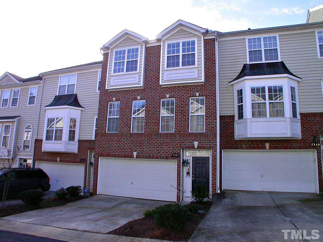 7347 Doverton Court Raleigh, NC 27615 - Photo 2 of 20 a front view of a residential apartment building with a yard