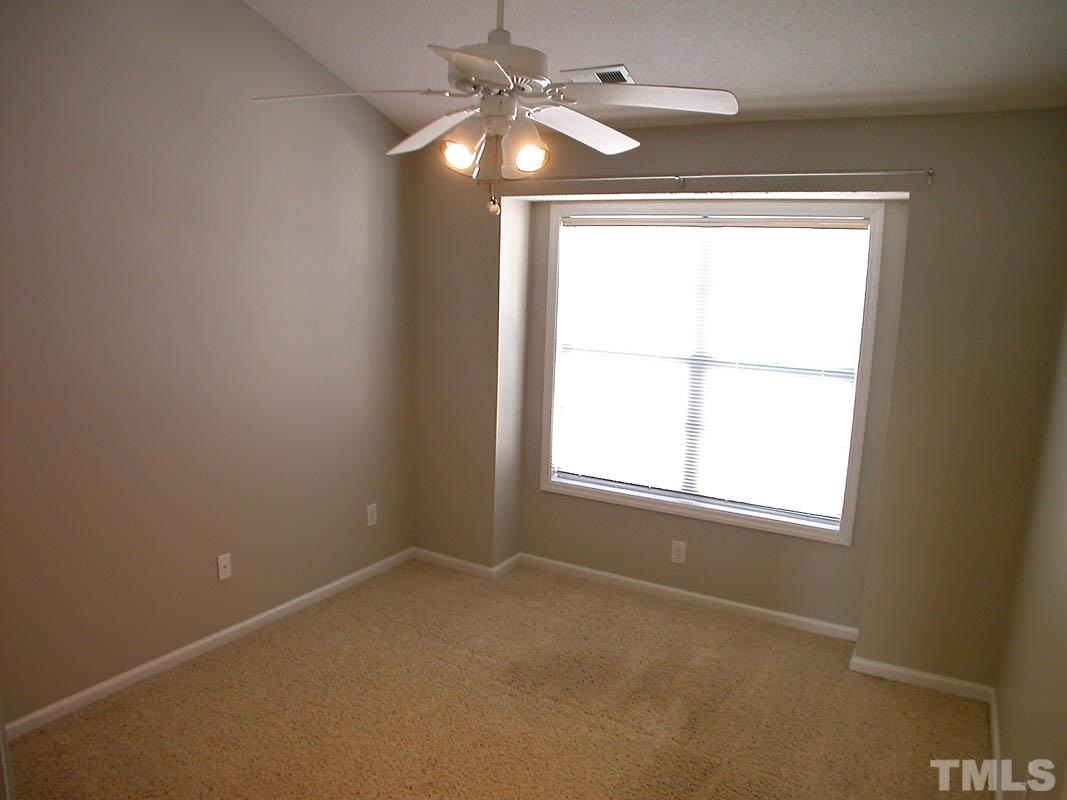 7347 Doverton Court Raleigh, NC 27615 - Photo 14 of 20 an empty room with a window and a fan