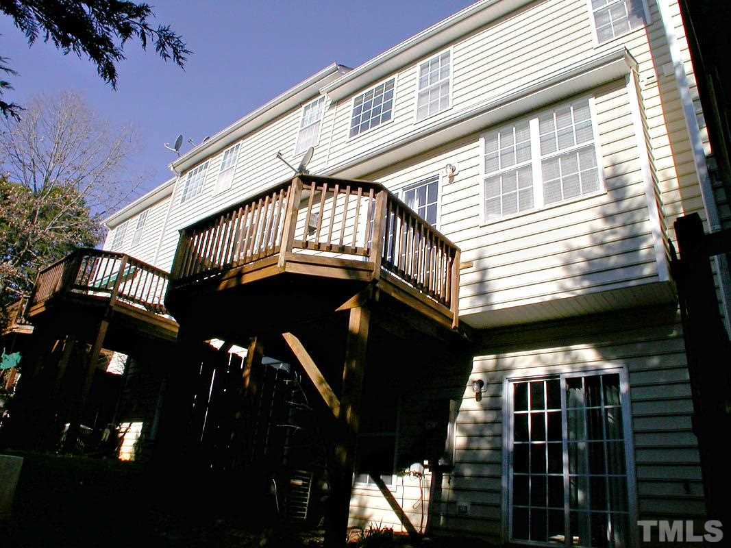 7347 Doverton Court Raleigh, NC 27615 - Photo 19 of 20 a view of a house with backyard and deck
