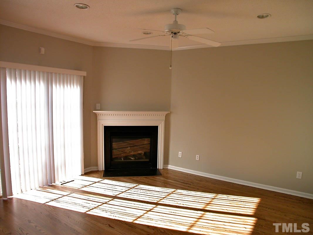 7347 Doverton Court Raleigh, NC 27615 - Photo 6 of 20 a view of an empty room with window and fire place