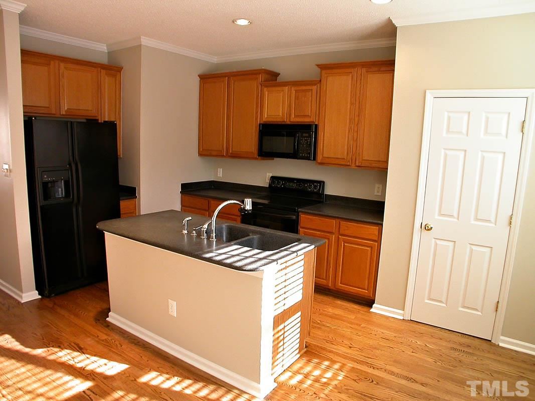7347 Doverton Court Raleigh, NC 27615 - Photo 9 of 20 a kitchen with stainless steel appliances granite countertop a stove a refrigerator and a sink