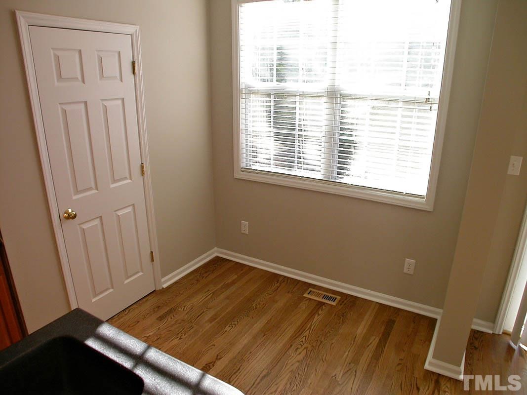 7347 Doverton Court Raleigh, NC 27615 - Photo 10 of 20 a view of a room with wooden floor and windows