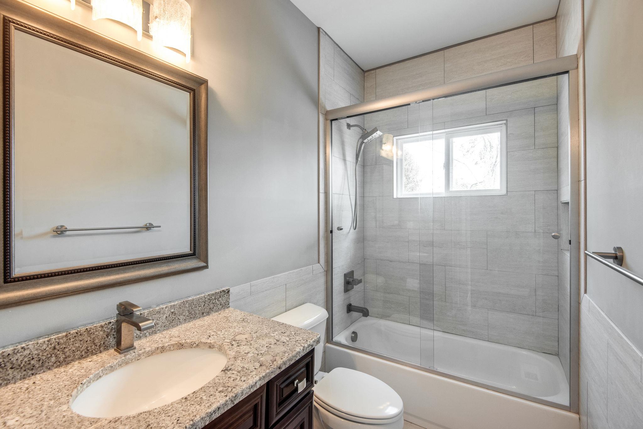 7316 Allans Ridge Lane Fairview, TN 37062 - Photo 20 of 30 a bathroom with a granite countertop sink toilet and shower