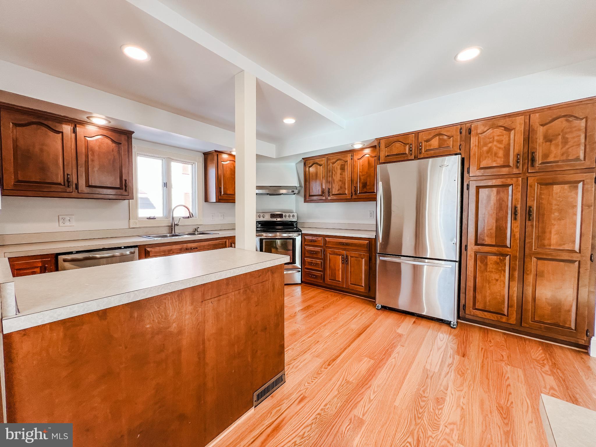 126 South Orange Street Beavertown, PA 17813 - Photo 6 of 25 a large kitchen with stainless steel appliances wooden floors and wooden cabinets