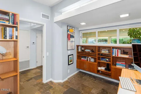 a living room with furniture and a potted plant