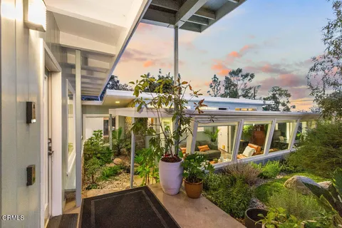 a front view of a house with a garden