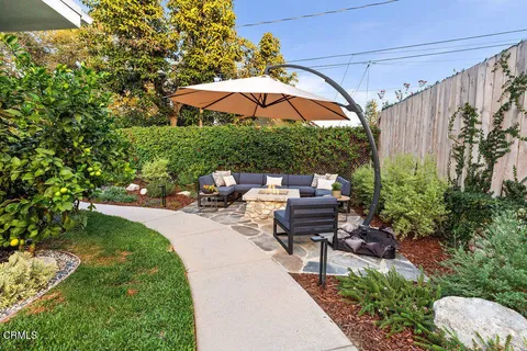 a view of a backyard with sitting area