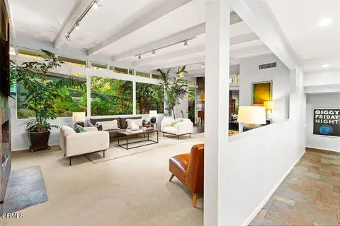 a living room with furniture a fireplace and a large tree