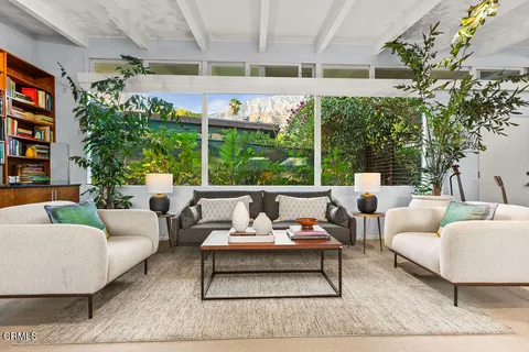 a living room with furniture and a table