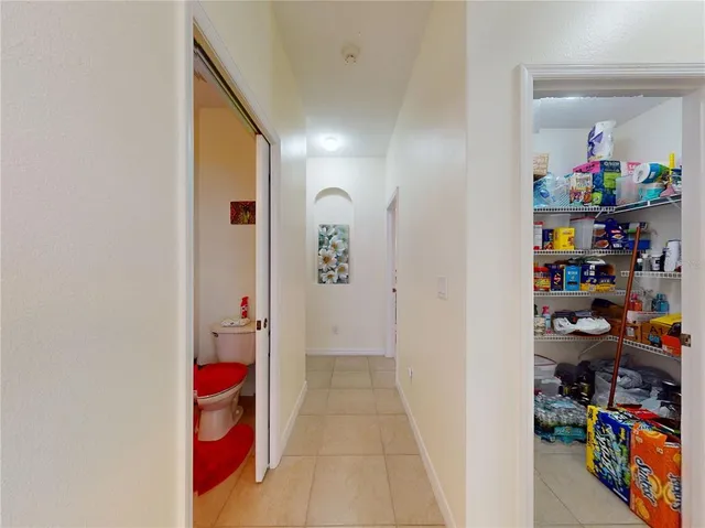 a spacious bedroom with a bed and a chandelier