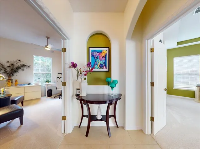 a view of a dining room with furniture and a potted plant