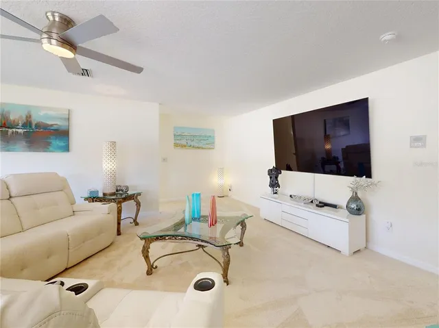 a view of living room with furniture and wooden floor