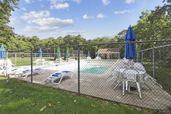 a view of a deck with a floor to ceiling window next to a yard