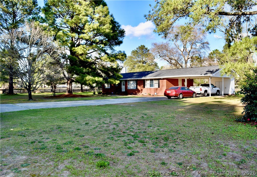5309 Tobacco Road Orrum, NC 28369 - Photo 37 of 44 a front view of a house with garden