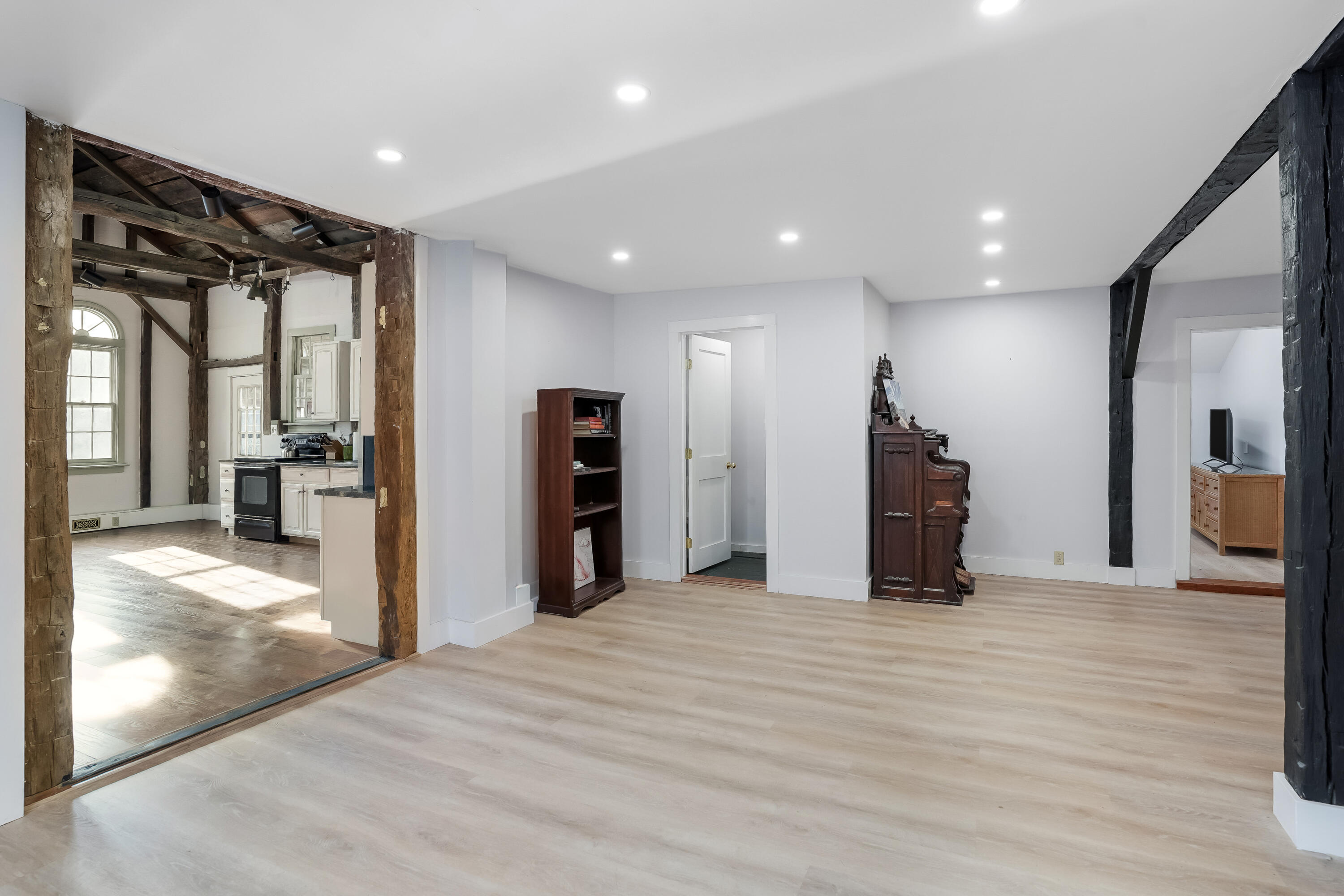 32 Norton Orchard Road Edgartown, MA 02539 - Photo 7 of 26 a view of an empty room with wooden floor and a kitchen