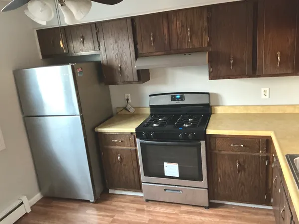 a kitchen with a refrigerator and a stove