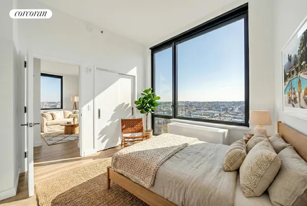 a bedroom with a large bed and a chandelier