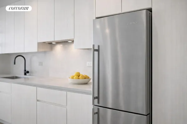 a close view of a sink and cabinets in the kitchen
