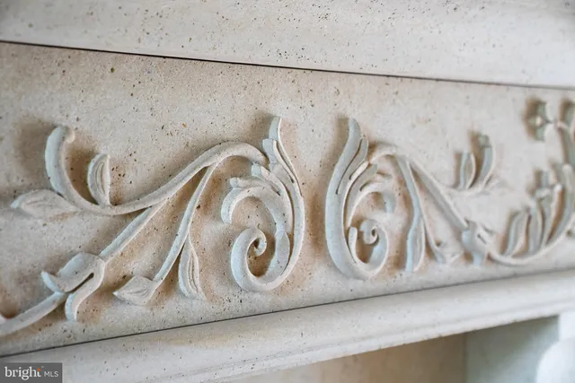 a living room with fireplace furniture and a chandelier