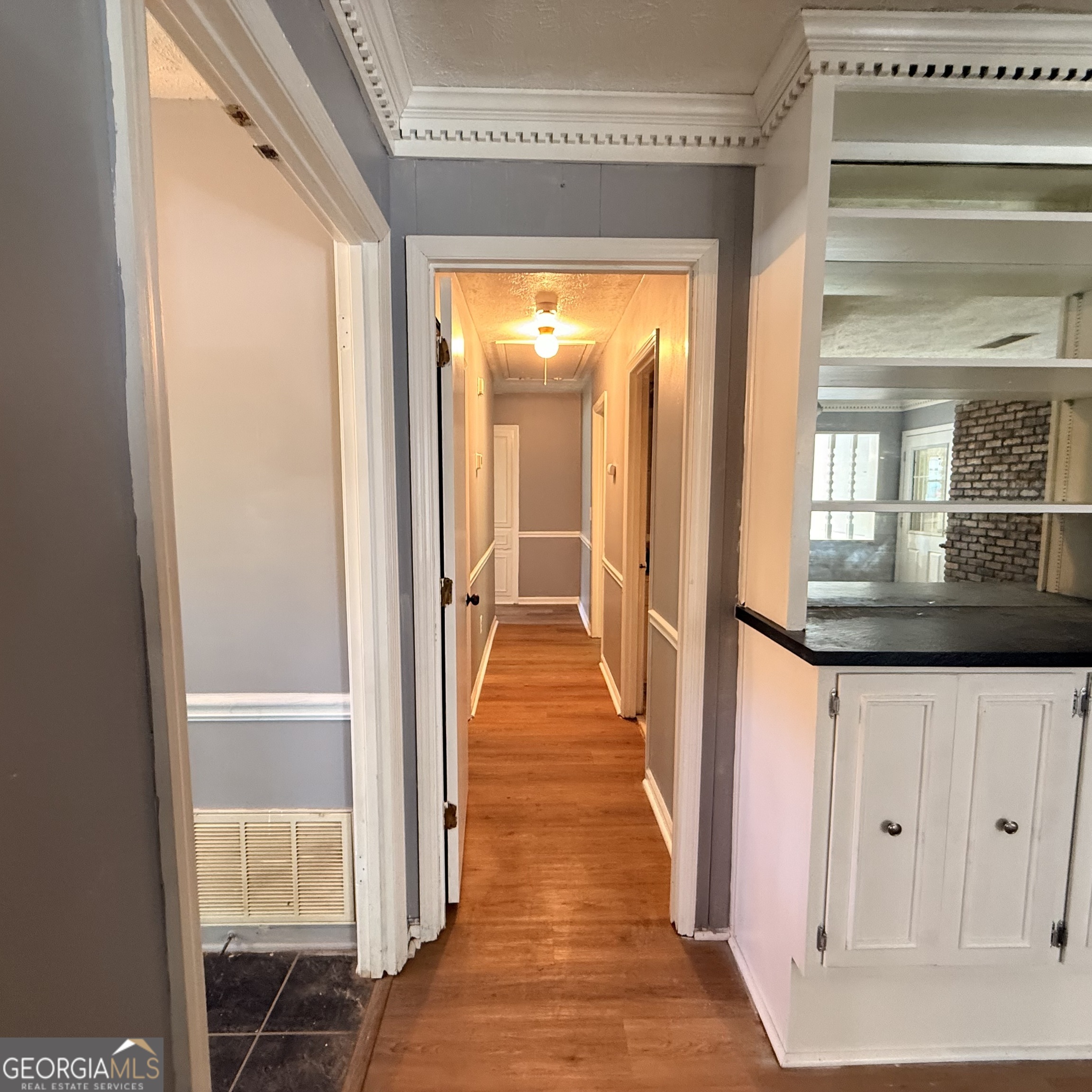 6282 Starlight Drive Columbus, GA 31909 - Photo 13 of 19 a view of a hallway with wooden floor and staircase