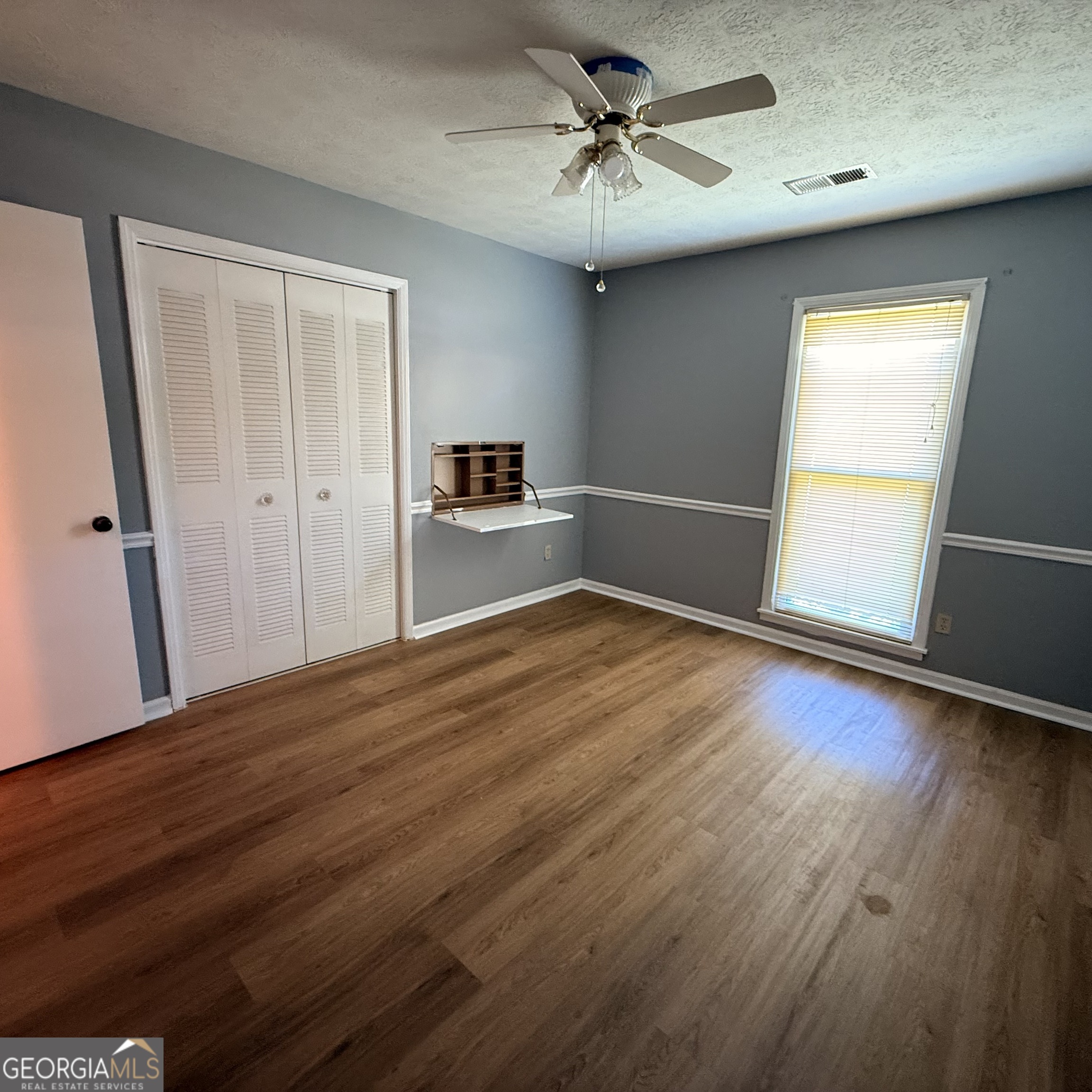 6282 Starlight Drive Columbus, GA 31909 - Photo 14 of 19 a view of empty room with wooden floor and fan