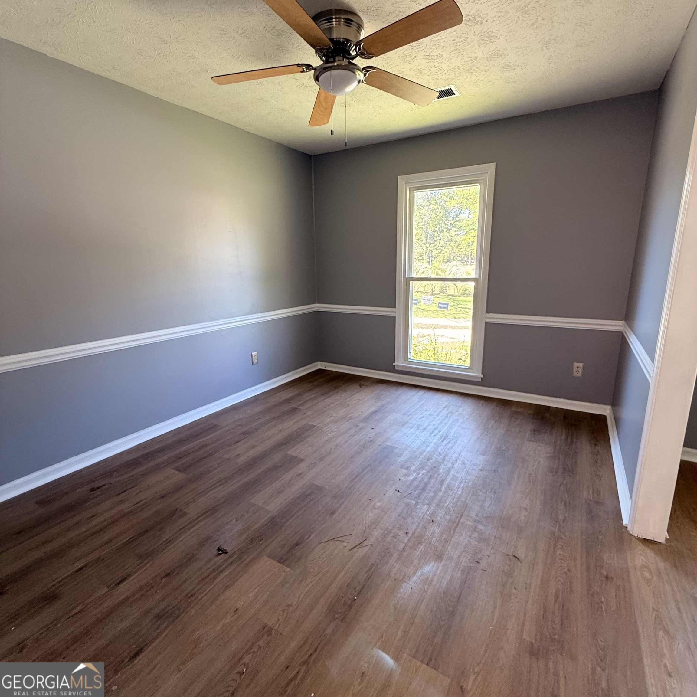 6282 Starlight Drive Columbus, GA 31909 - Photo 17 of 19 an empty room with wooden floor and windows