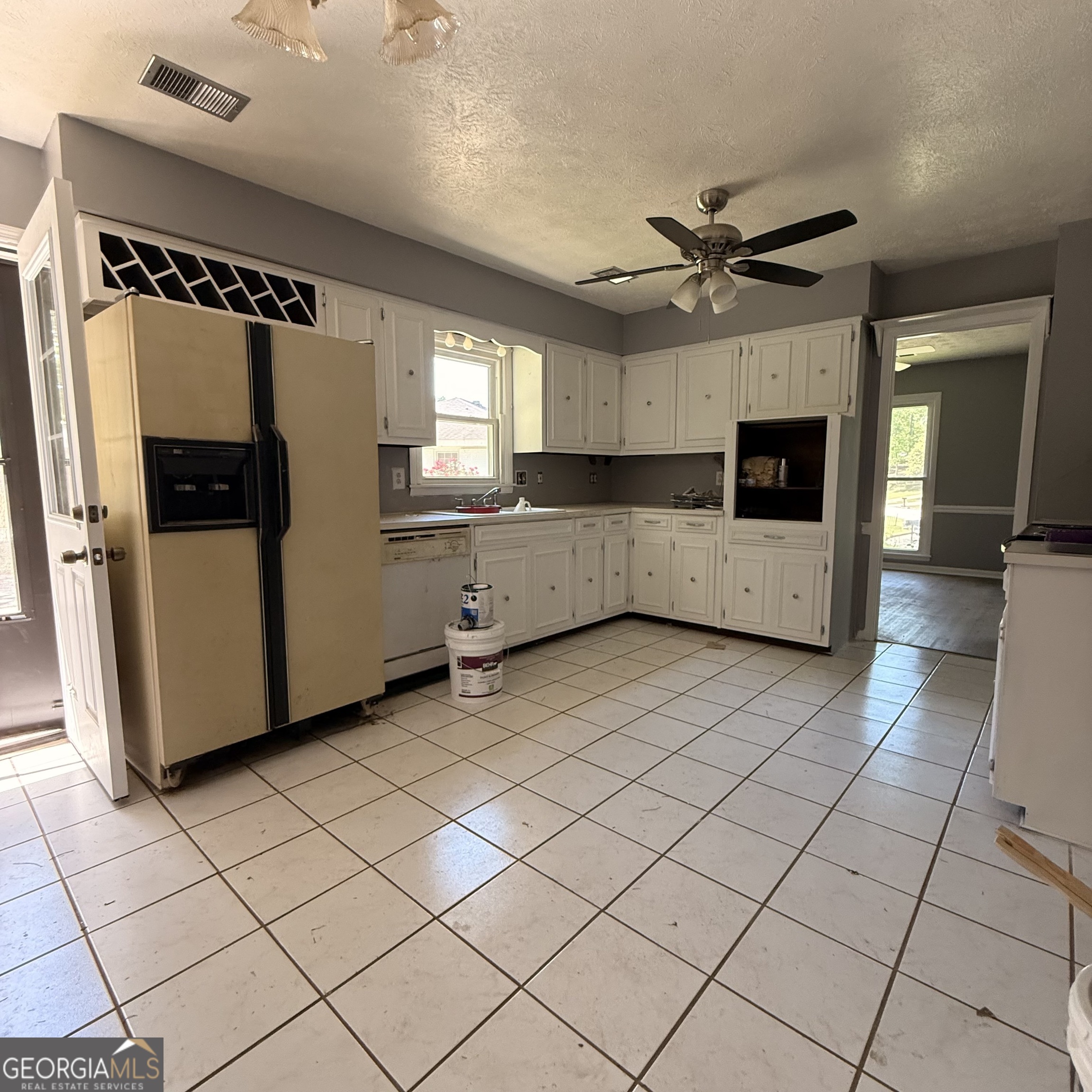 6282 Starlight Drive Columbus, GA 31909 - Photo 4 of 19 a large white kitchen with a stove a sink dishwasher and a refrigerator with wooden floor