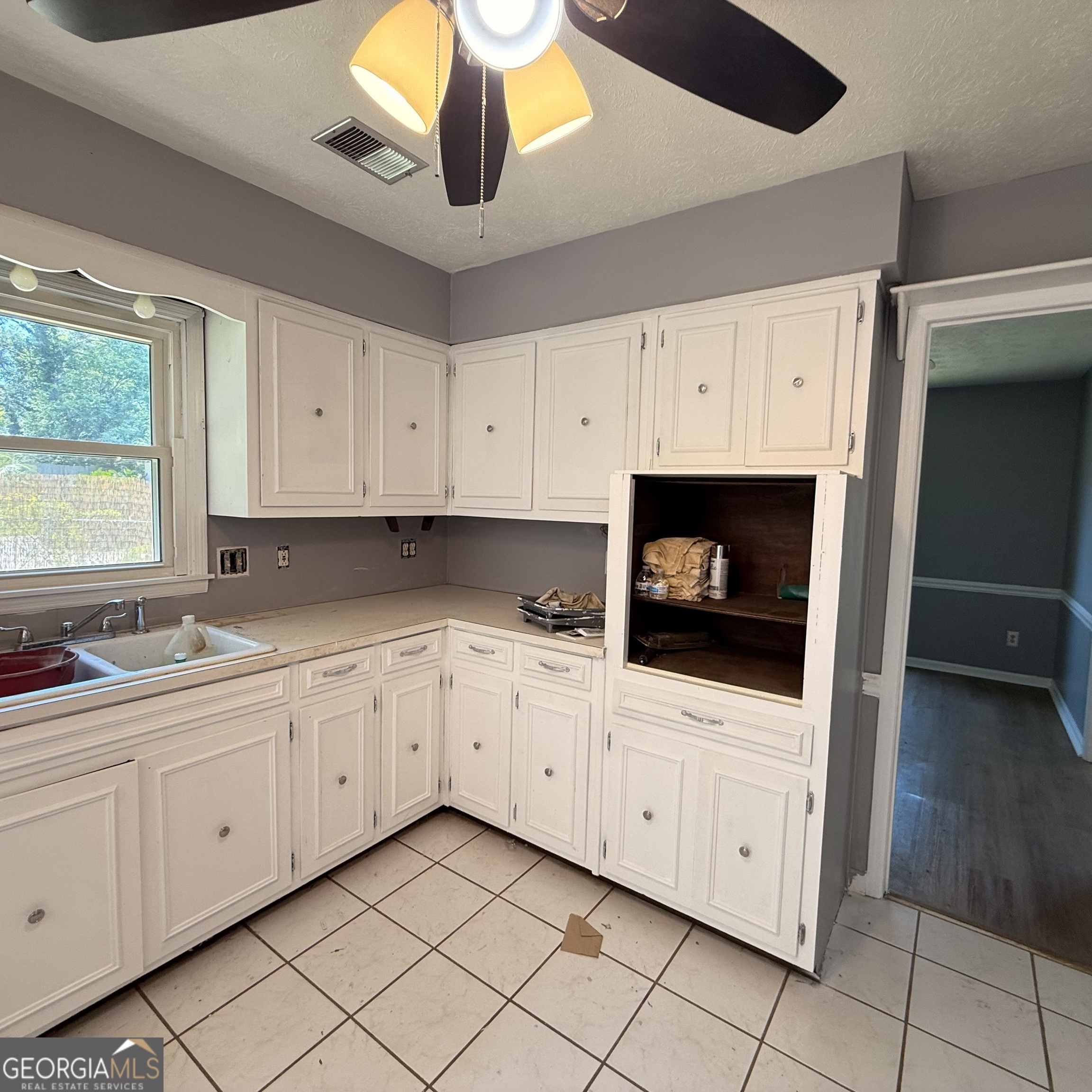 6282 Starlight Drive Columbus, GA 31909 - Photo 6 of 19 a kitchen with white cabinets appliances and a sink