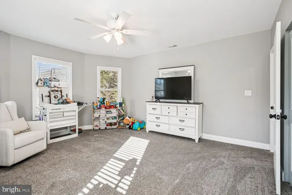 a view of a livingroom with furniture and a flat screen tv