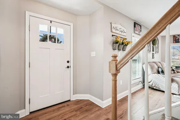 a view of entryway with wooden floor and stairs