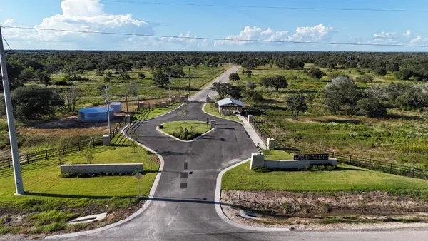 an aerial view of a house with a yard basket ball court and outdoor seating
