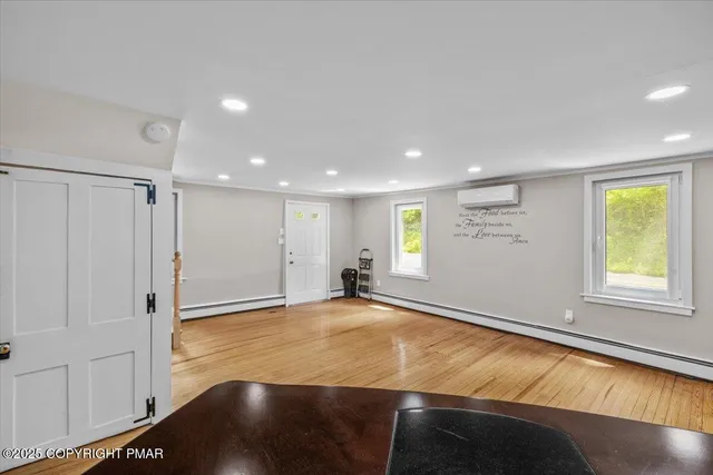 a living room with furniture and a ceiling fan