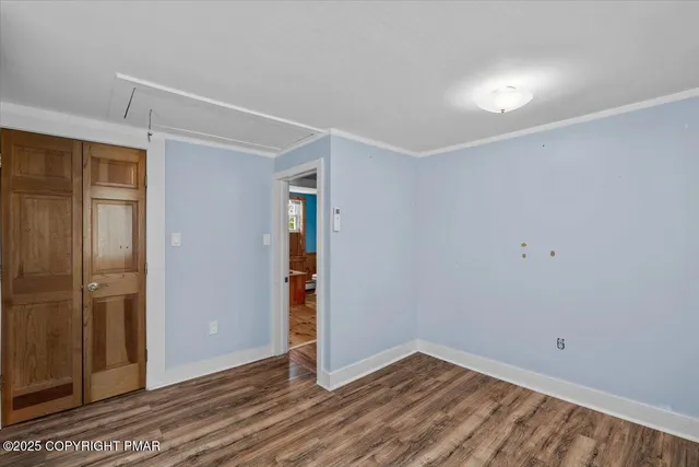 a view of entryway and hall with wooden floor