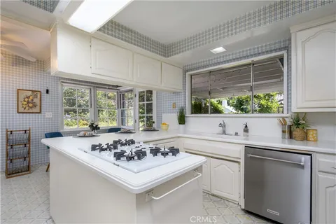 a kitchen with a sink stove and window
