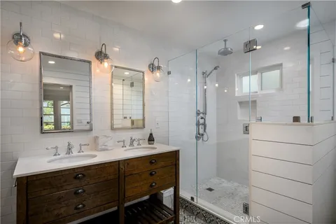 a bathroom with a shower sink double and mirror