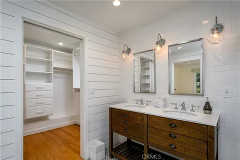 a bathroom with a shower sink vanity and mirror