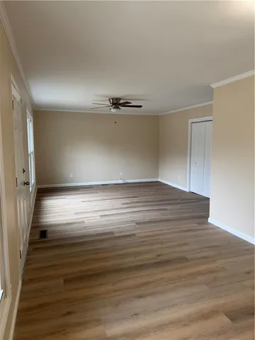 a view of room with window and wooden floor