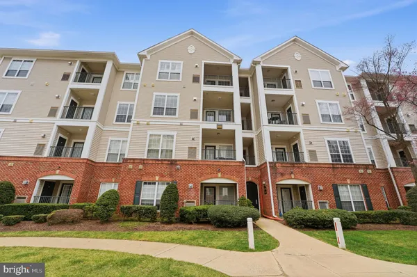 a front view of a residential apartment building with a yard