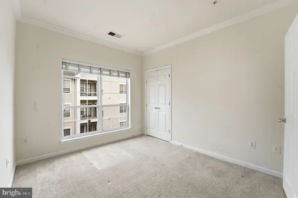 a bedroom with furniture and a large window