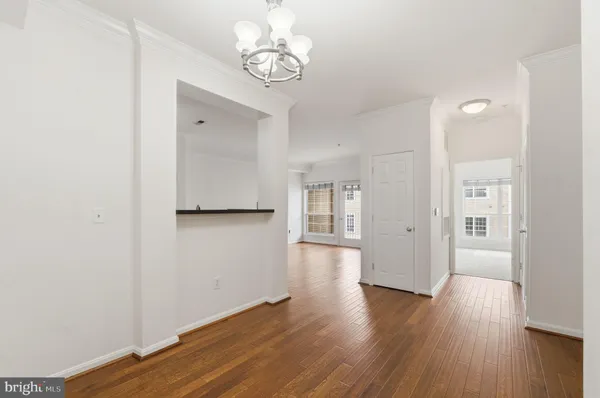a view of a room with wooden floor and window