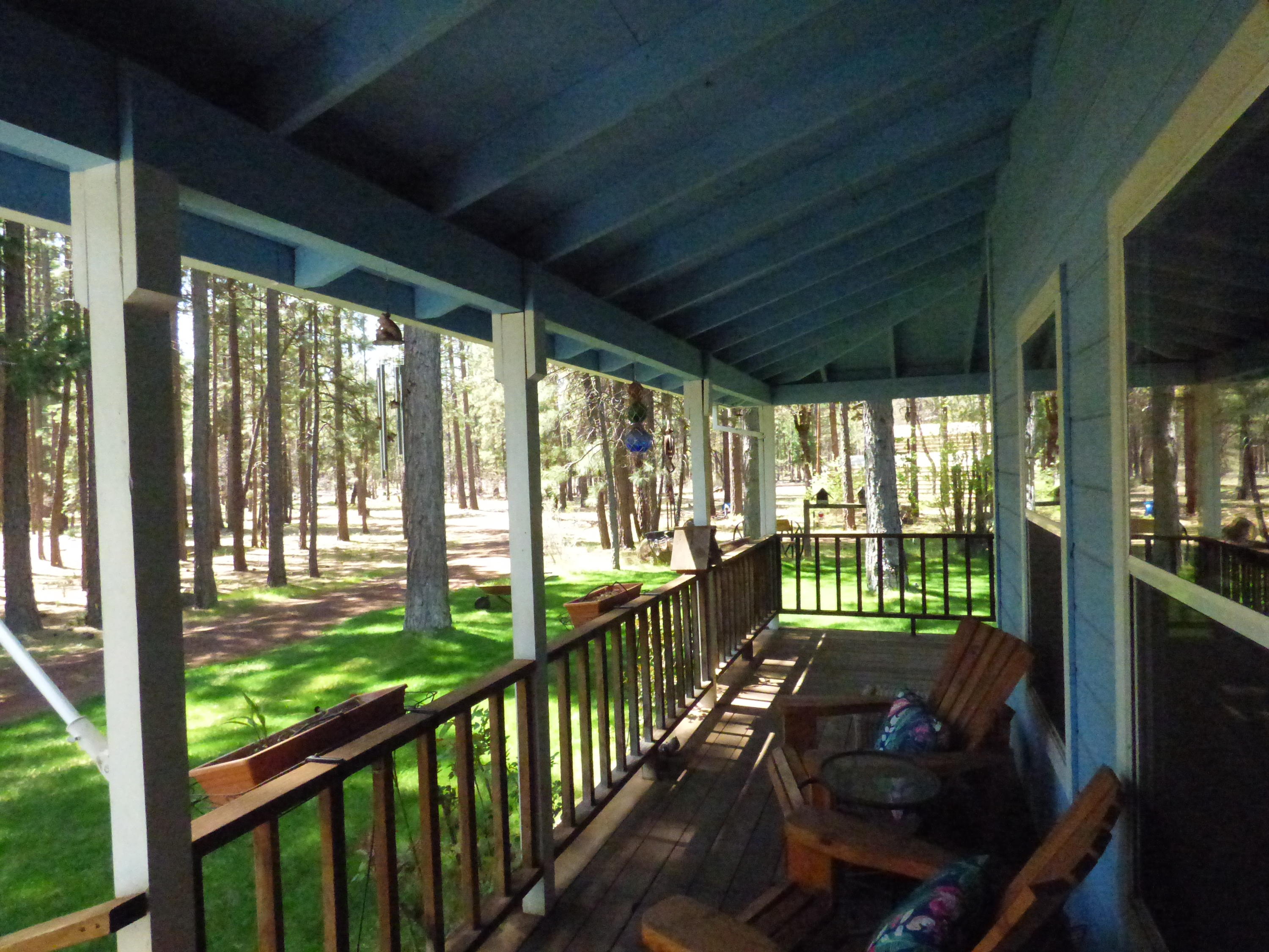 50 Red Rock Road McArthur, CA 96056 - Photo 19 of 24 a view of a porch with furniture and floor to ceiling window