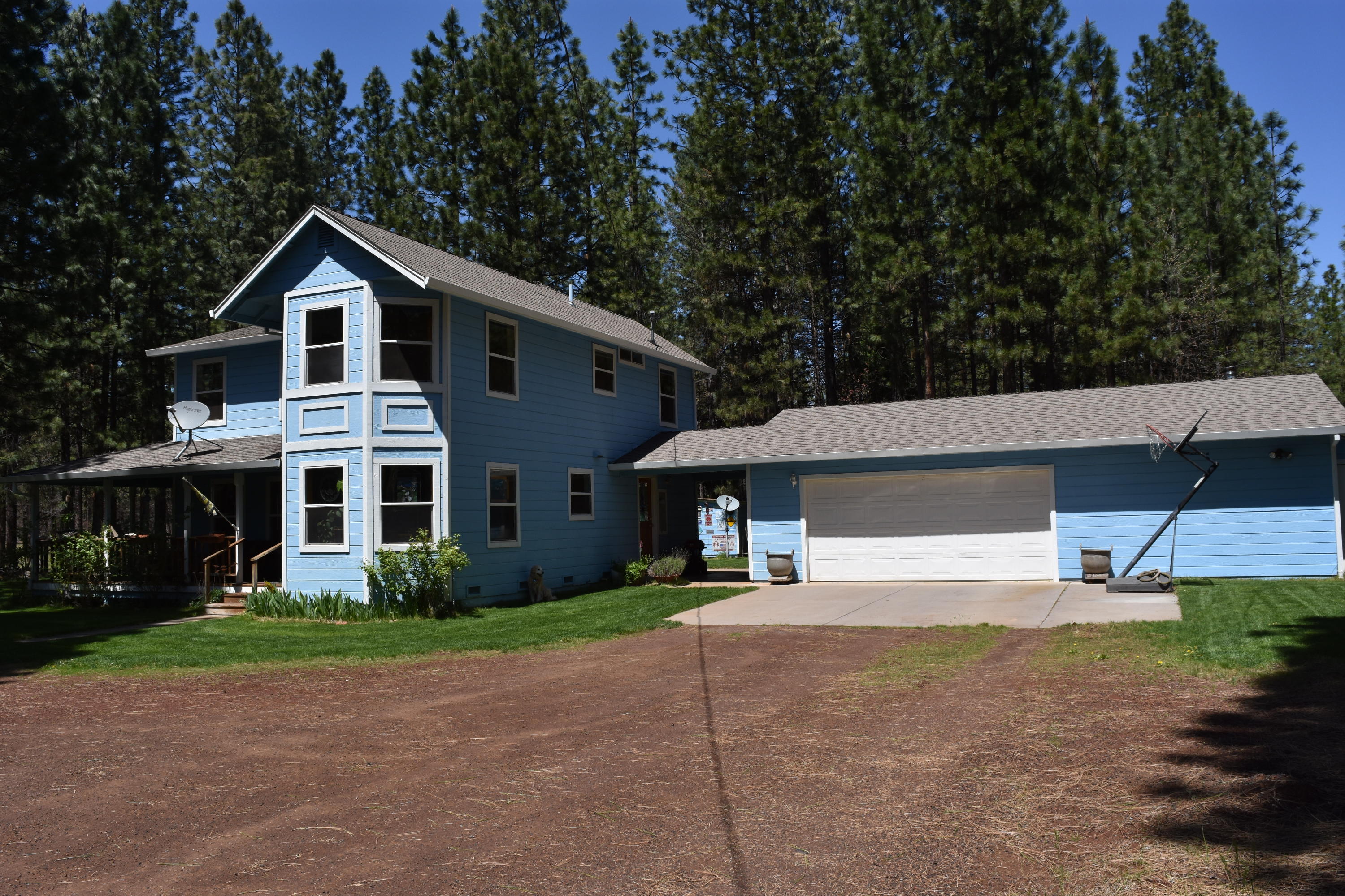 50 Red Rock Road McArthur, CA 96056 - Photo 2 of 24 a front view of a house with a yard and garage