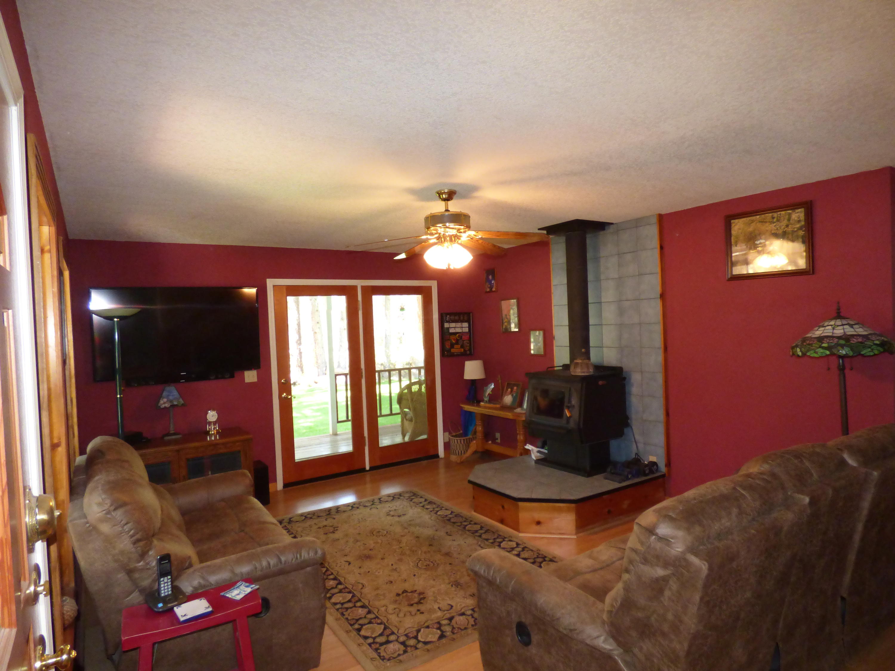 50 Red Rock Road McArthur, CA 96056 - Photo 7 of 24 a living room with furniture a floor to ceiling window and a flat screen tv
