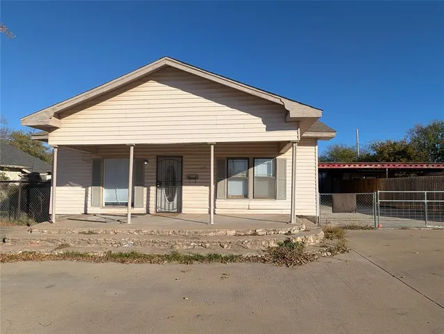 a front view of a house with a sitting area