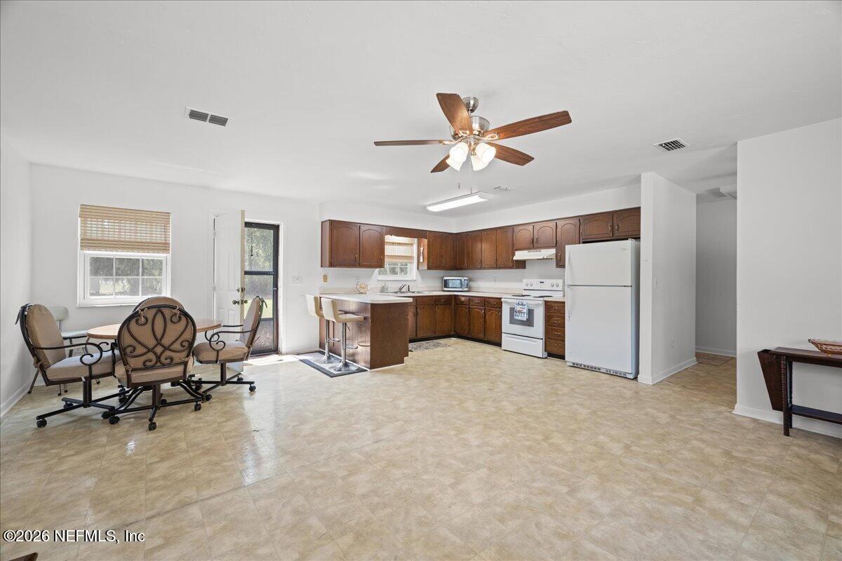 986 Highway 20 Interlachen, FL 32148 - Photo 14 of 53 a view of a livingroom with furniture and a kitchen