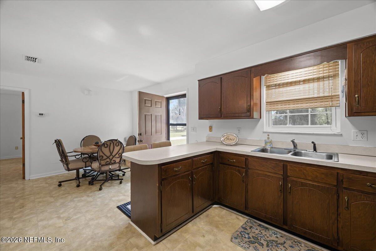 986 Highway 20 Interlachen, FL 32148 - Photo 17 of 53 a kitchen with a sink and chairs