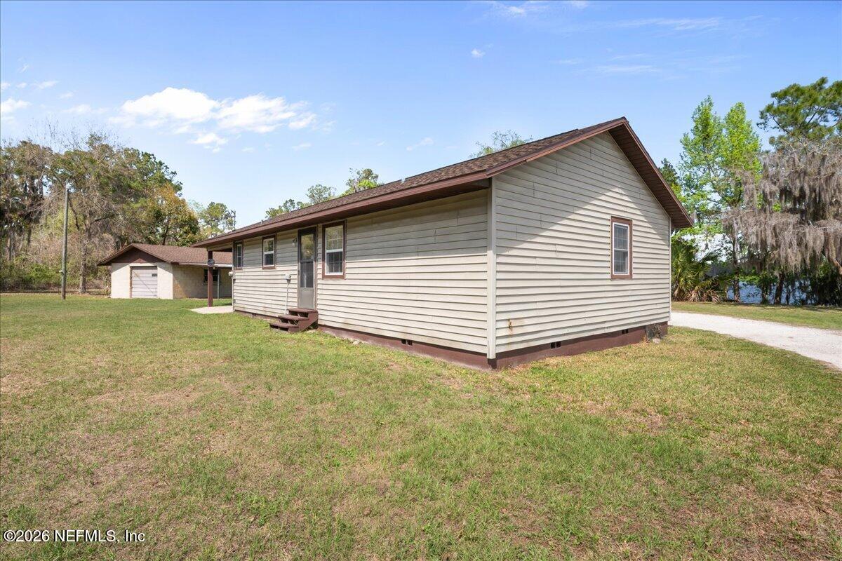 986 Highway 20 Interlachen, FL 32148 - Photo 32 of 48 a view of a house with a backyard